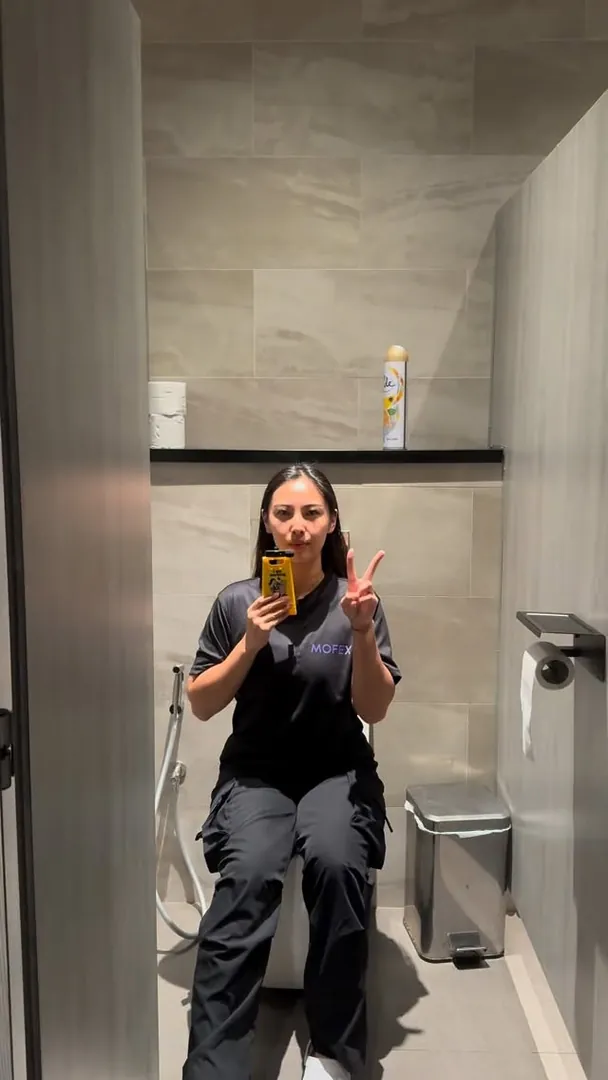 Mofex team member in uniform taking a mirror selfie