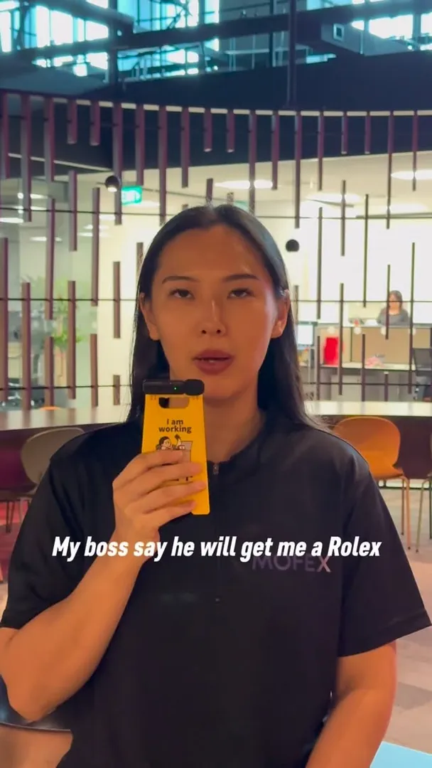 Mofex team member holding a phone in the office