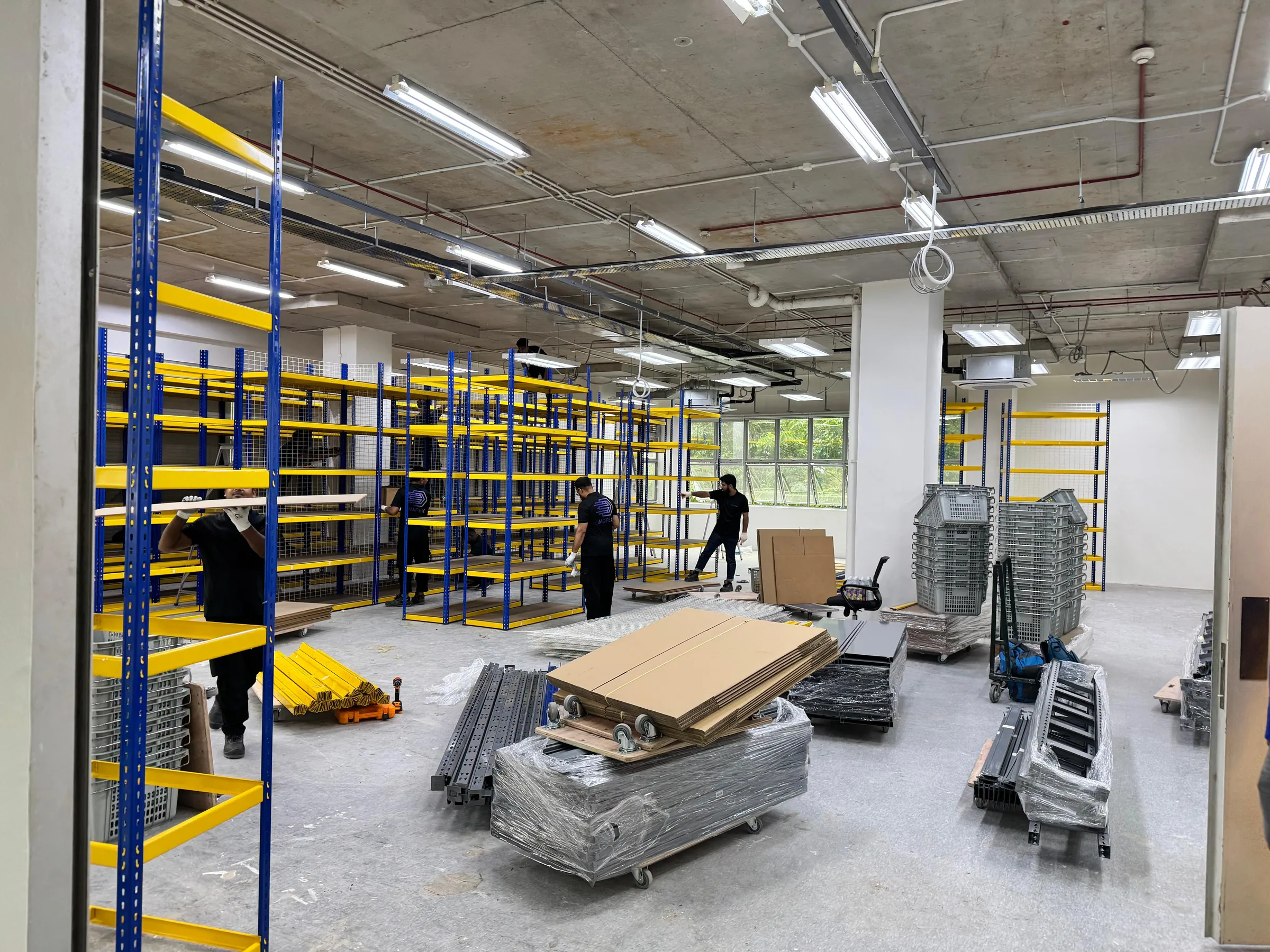 Mofex crew installing warehouse storage racking during a commercial relocation